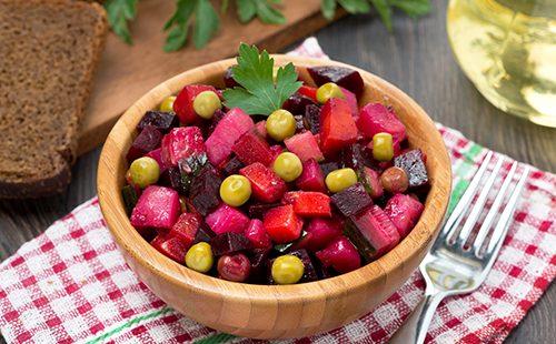 Beetroot salad na may mga gisantes sa isang kahoy na mangkok