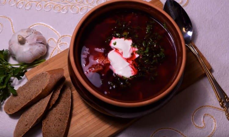 Maaari kang magdagdag ng kulay-gatas at gulay sa borsch na may sauerkraut kapag naglilingkod.