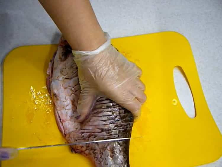 Upang makagawa ng pinirito na crucian carp, gumawa ng mga incision sa isda