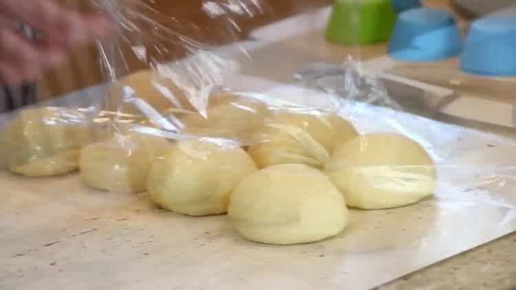 Upang makagawa ng burger buns, ilagay ang kuwarta sa ilalim ng pelikula