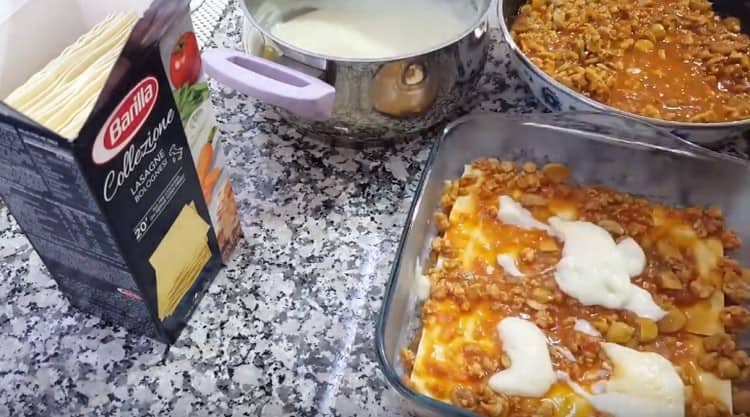 Susunod, ilatag ang mga sheet ng lasagna at takpan muli gamit ang mga sarsa.