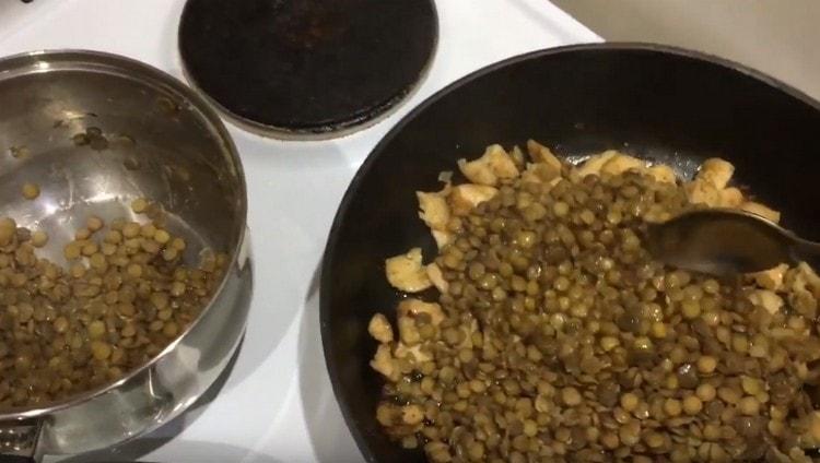 Inilipat namin ang mga pinakuluang lentil sa kawali sa manok na may mga sibuyas.